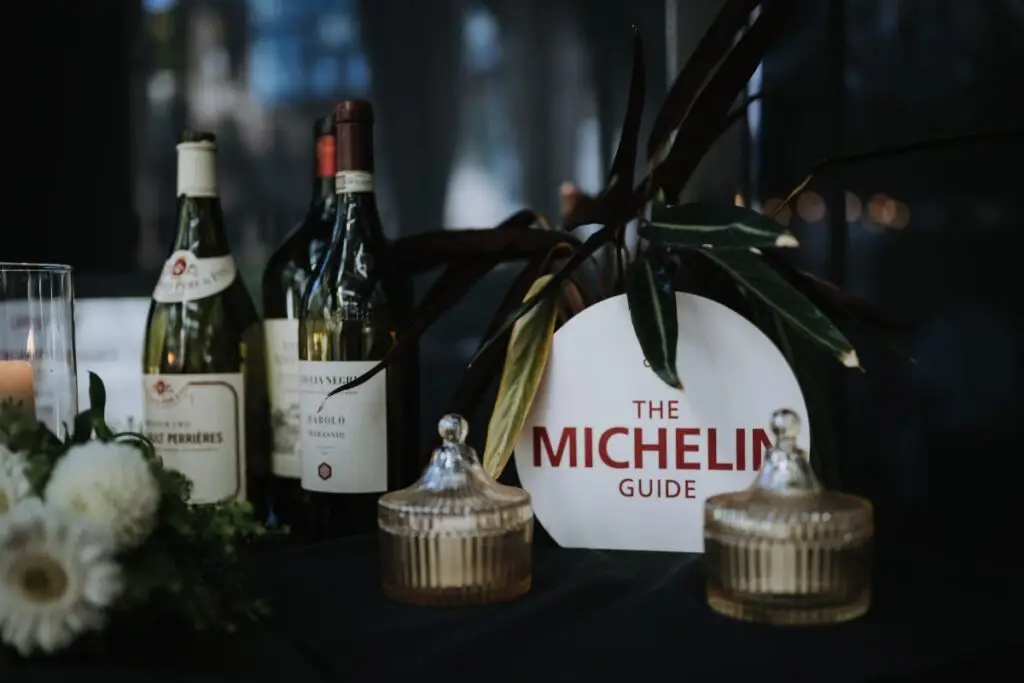 Wine bottles, floral décor, and a MICHELIN Guide plaque displayed at Acquafarina