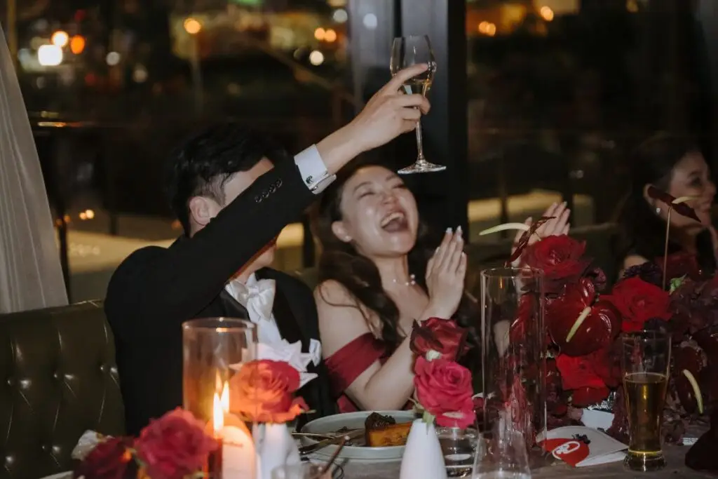 Wedding guests raising a toast during a reception at Acquafarina in Vancouver