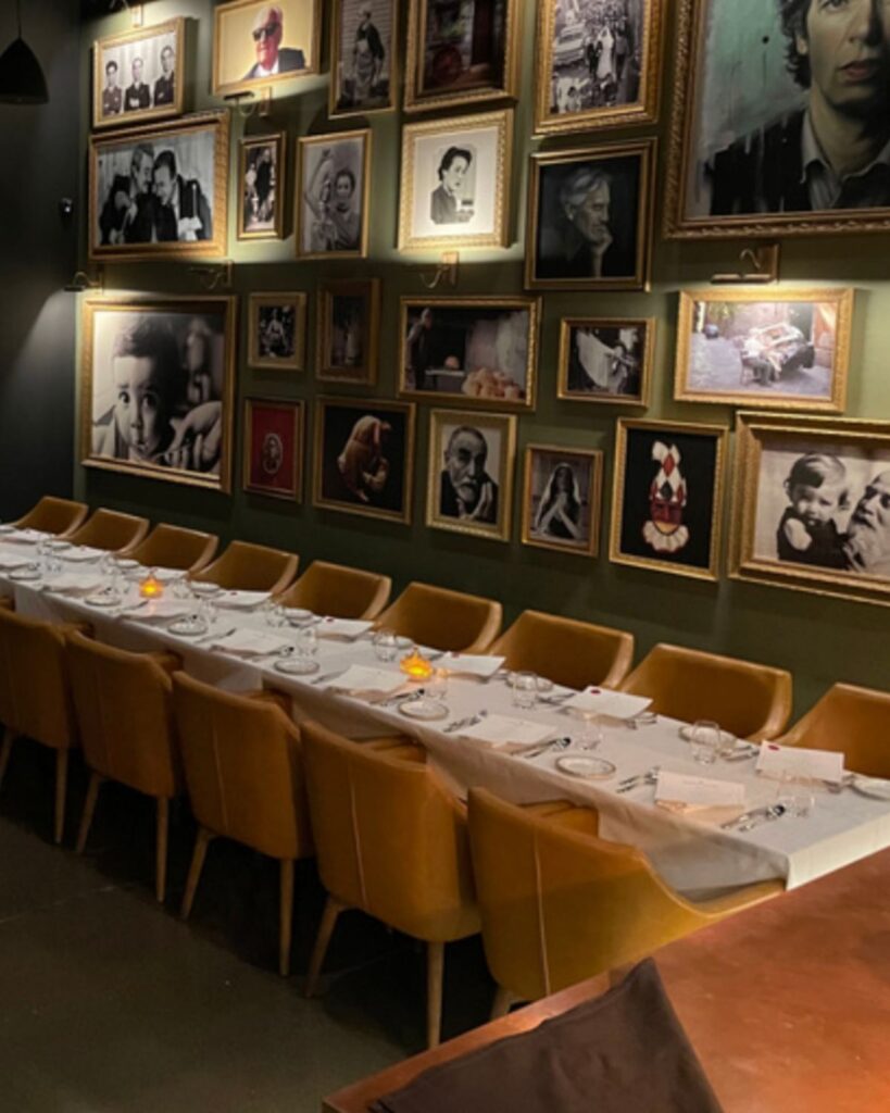 Long wedding reception table beneath framed artwork at Acquafarina in Vancouver