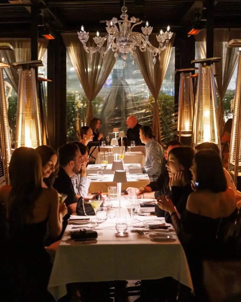 Guests dining at an elegant wedding reception table at Acquafarina in Vancouver