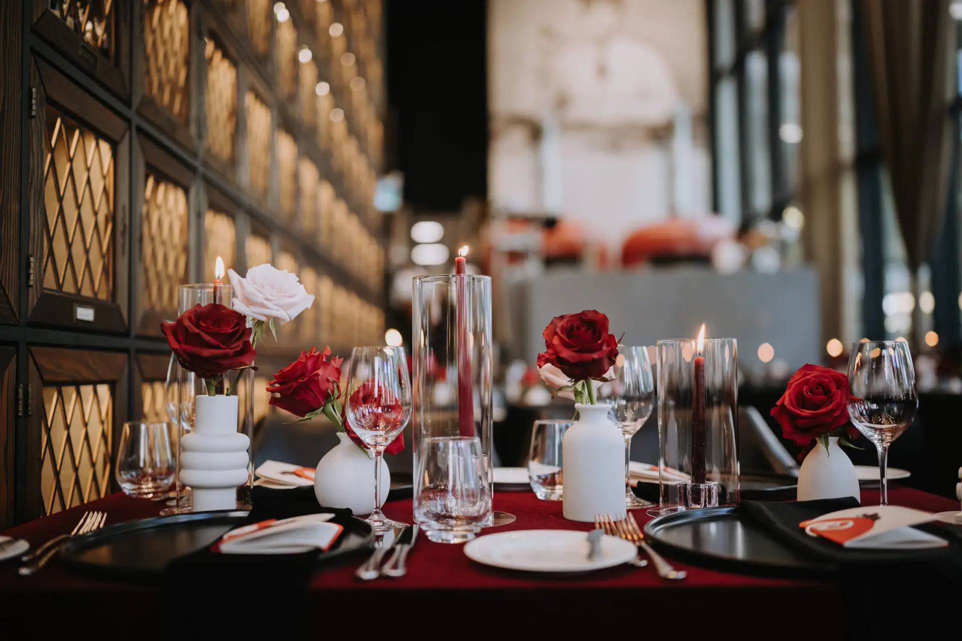 Wedding reception table with red roses and elegant place settings at Acquafarina in Downtown Vancouver