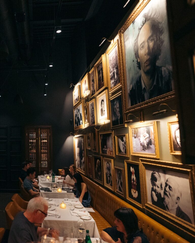 Private dining table beside Acquafarina’s portrait gallery wall in downtown Vancouver