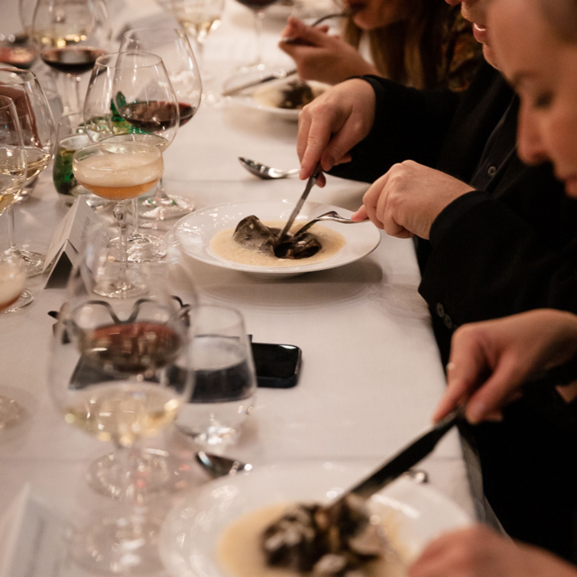 Corporate guests enjoying dinner and wine at Acquafarina