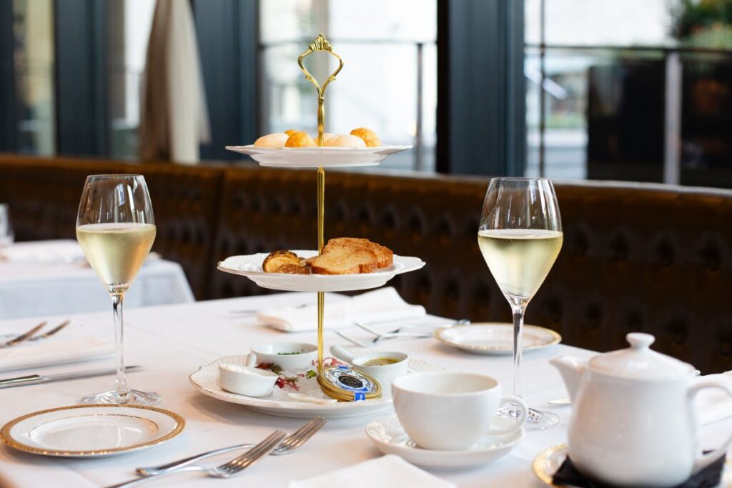 Elegant table setting with wine and plated dishes at Acquafarina in Vancouver